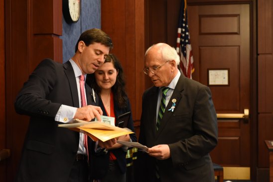 Ben Portis, Entergy's director of federal governmental affairs, provides simulation instructions to Rep. Paul Tonko (D-NY). Photo by Elias Kontogiannis for Catholic Charities USA.